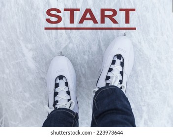 Legs Of Ice Skater With Start Sign On The Ice Rink, View From Above