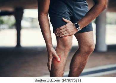 Legs, injury and hand in pain outdoor or fitness, wellness and exercise or training. Joint problem, runner and person athlete in city or cardio, accident and arthritis in knee with red glow in street