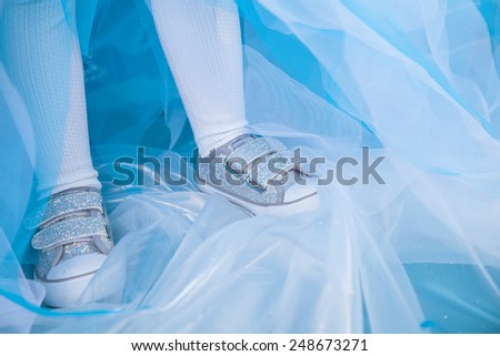legs of little girl in princess dress