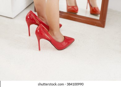 Legs Of Little Girl Wearing Red High Heels