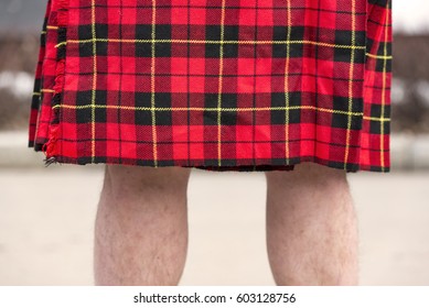 Legs Of A Man In Scottish Red Kilt