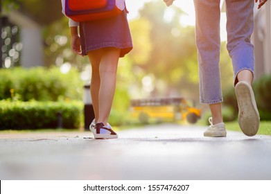 Legs Of Mother And Daugther Walking From Home To School Bus, Going Back To School In The First Day, Worry Opf Mom Sending Girl To School