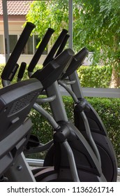 Legs On Elliptical Trainer,Healthy Lifestyle Concept. Spinning Class With Empty Bikes. Fitness, Sport, Training In Home Fitness Room