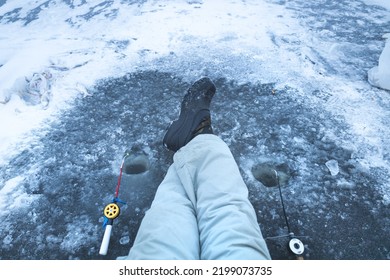 Legs On Ice In Winter Boots And Warm Pants, Winter Fishing, Ice Hole, Winter Hobby