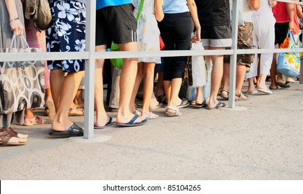 Legs Of People Standing In Line One After Another