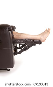 Legs Raised On A New Leather Recliner Chair Isolated On A White Background