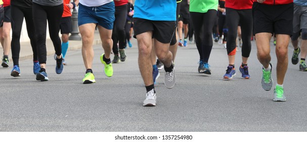 Legs Of Runners At Footrace On The Road Of The City