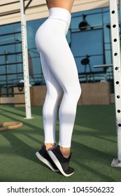 Legs Of A Sexy Girl In White Leggings. Mock-up. Outdoor Gym.