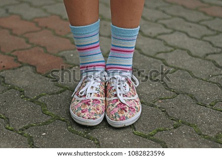Legs and shoes of young girl