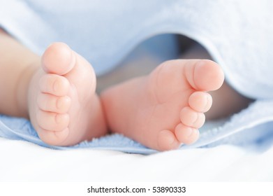 Legs of the small baby in a bath towel