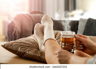 Legs in socks on the background of the spring window with free space for an advertising product