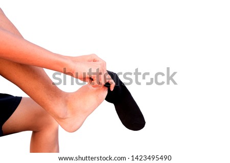 Legs of teenage boys Wearing black socks, isolated on a white background. selection focus.