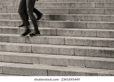 the legs of two characters walking down the stairs