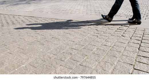 Legs of two men with shadow