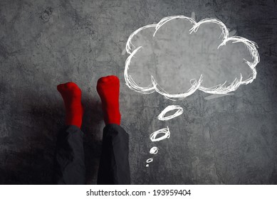 Legs Up The Wall, Putting Feet Up With Think Balloon. Man Wearing Red Socks In Relaxing Yoga Pose With His Legs On The Wall.