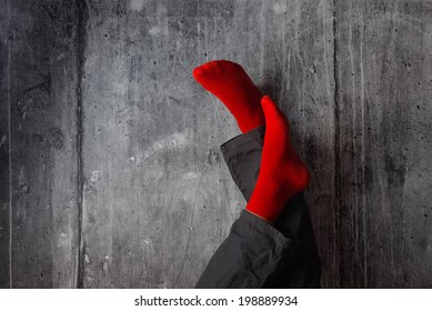 Legs Up The Wall, Putting Feet Up. Man Wearing Red Socks In Relaxing Yoga Pose With His Legs On The Wall.