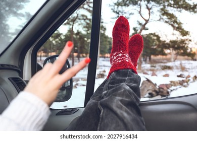 Legs Of Woman Sitting In Car On Winter Day