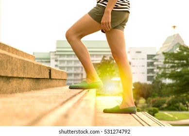 Legs of women walking up the stair in success concept