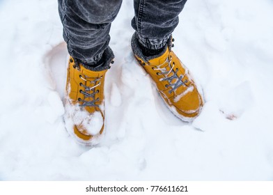 Legs yellow shoes in snow