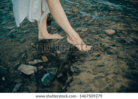 legs of a young girl in river water