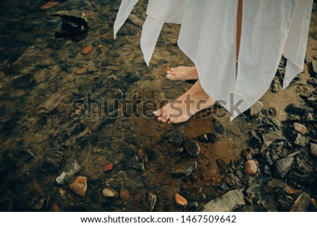 legs of a young girl in river water