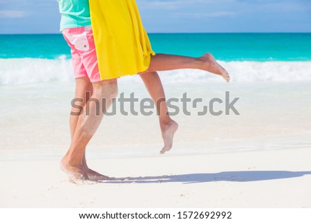 legs of young kissing couple on tropical turquoise boracay beach