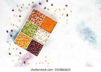 Legumes and beans assortment, Healthy vegan protein food, Mixed dried legumes and cereals isolated on white background, top view with copy space, Legumes and beans assortment in different bowls.