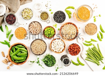 Legumes, beans and sprouts. Dried, raw and fresh, top view. Red beans, lentils, mung beans, chickpeas, soybeans, edamame, green peas, Healthy diet food, vegan protein, micronutrients fiber sources