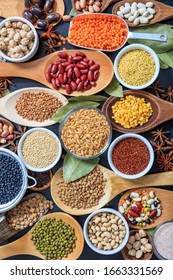 Legumes pulses background. Legumes variety flat lay. Pulses and herbs dried uncooked composition top view