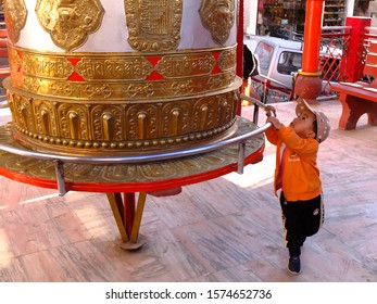 Leh, Ladakh, Jammu and Kashmie / India - 14th September 2019 - A boy rotating Tibetan prayer wheel
