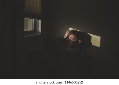 Lehi, UT / United States - November 12, 2017: Young Male Model Sitting By Window With Light Shining On His Face 