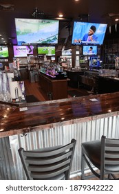 Lehi, Utah, October 2020.  An Empty Sports Bar With No People With Televisions And Alcohol Bottles On Display.
