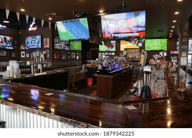 Lehi, Utah, October 2020.  An Empty Sports Bar With No People With Televisions And Alcohol Bottles On Display.
