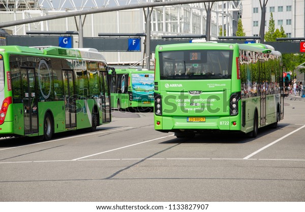 Leiden, Netherlands, 05-07-2018: A couple\
of buses from the dutch compamy arriva standing at a bus station\
next to leiden central station in the\
Netherlands
