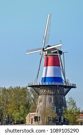 Leiden, The Netherlands, April 25 2018: Windmill De Valk Already Dressed In The National Red, White And Blue On The Occasion Of King's Day, Two Days Later