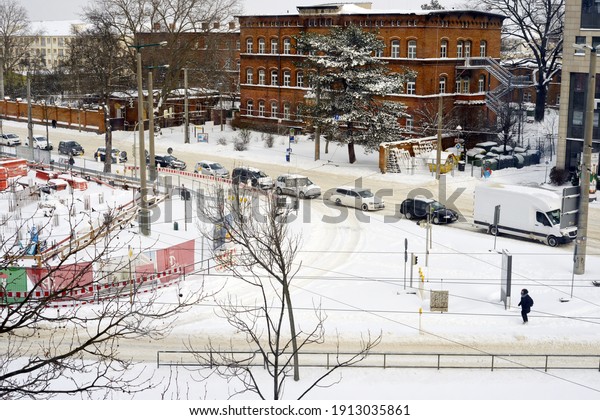 Leipzig, Germany\
02-08-2021 traffic jam during winter snow covered streets cars\
waiting on traffic\
lights
