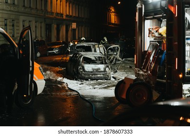 LEIPZIG, GERMANY - 12.04.2020: Firetruck And Burned Out Car At Night