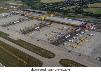 Leipzig Schkeuditz, Germany, June 2021 DHL cargo hub with main cargo apron, main buildings and hangar and many cargo airplanes parked on apron - aerial view