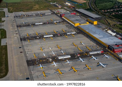 Leipzig Schkeuditz, Germany, June 2021 DHL cargo hub with main cargo apron, main buildings and hangar and many cargo airplanes parked on apron - aerial view