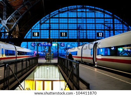 Leipzig train station at night with two speed trains about to leave