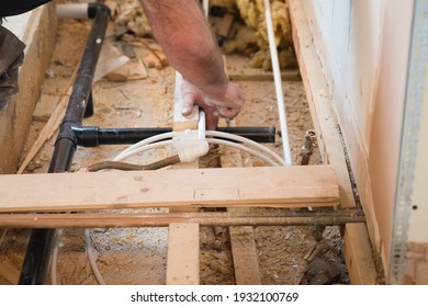 Leire, Leicestershire, UK. February 13 2021. A Plumber  Installing The Pipe Work For Underfloor Heating At A House In The UK.