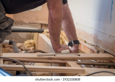 Leire, Leicestershire, UK. February 13 2021. A Plumber  Installing The Pipe Work For Underfloor Heating At A House In The UK.