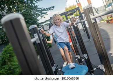 Leisure. Blonde Boy Running In Jungle Gym And Feeling Excited