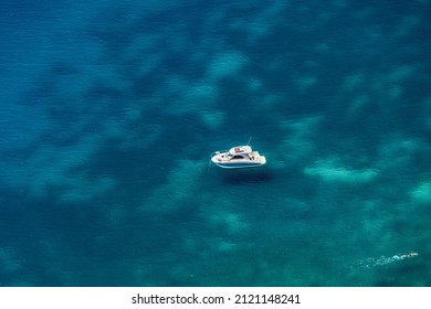 Leisure Boat Panoramic With Swimmer On A Turquoise Calm Sea. Elevated View Of Anchored Small Cruiser With A Person On Crystal Clear Waters.