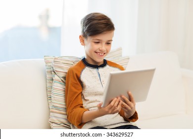 leisure, children, technology and people concept - smiling boy with tablet pc computer at home - Powered by Shutterstock