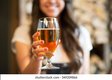 Leisure, Drinks, Degustation, People And Holidays Concept - Close Up Of Smiling Woman Hand Holding Glass Of Draft Lager Beer