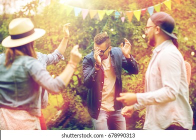 Leisure, Holidays, Fun And People Concept - Happy Friends Dancing At Summer Party In Garden