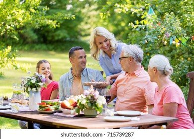 Leisure, Holidays And People Concept - Happy Family Having Festive Dinner Or Summer Garden Party