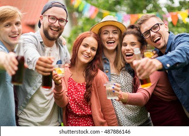 Leisure, Holidays, People, Reunion And Celebration Concept - Happy Friends With Drinks At Summer Garden Party