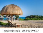 Leisure lounge chair under the cogonggrass hut on Yalong Bay Beach in Hainan Province during summer